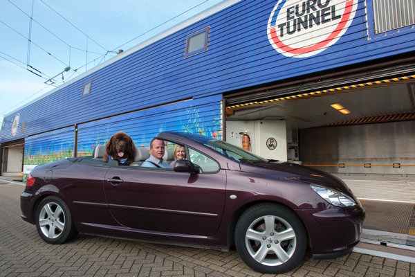 Newfoundland dog in convertible about to board Eurotunnel train